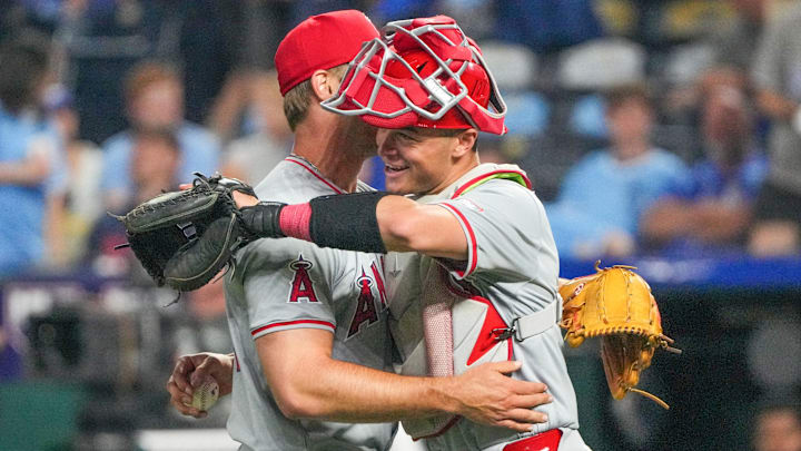 Aug 20, 2024; Kansas City, Missouri, USA; Los Angeles Angels pitcher Ben Joyce (44) celebrates with center fielder Kevin Pillar (12) after the win over the Kansas City Royals at Kauffman Stadium. Mandatory Credit: Denny Medley-Imagn Images