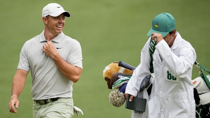 Apr 9, 2024; Augusta, Georgia, USA; Rory McIlroy laughs with his caddie, Harry Diamond, as they walk