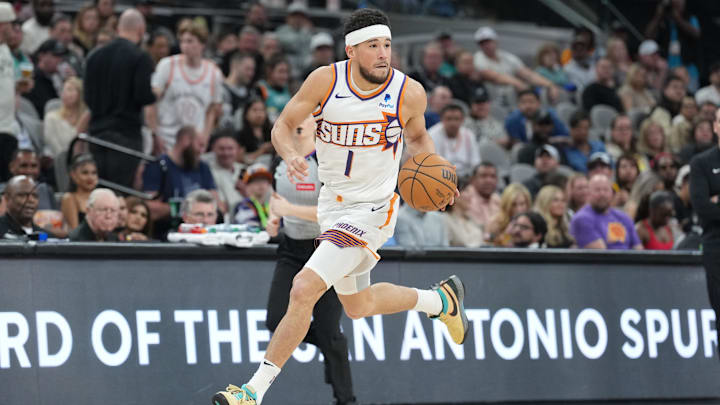 Phoenix Suns guard Devin Booker (1) dribbles.