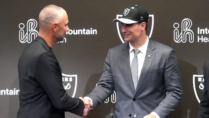 Apr 24, 2026; Henderson, NV, USA; Las Vegas Raiders quarterback Fernando Mendoza (right) shakes hands with general manager John Spytek at introductory press conference at Intermountain Health Performance Center after being selected as the No. 1 pick in the 2026 NFL Draft. Mandatory Credit: Kirby Lee-Imagn Images