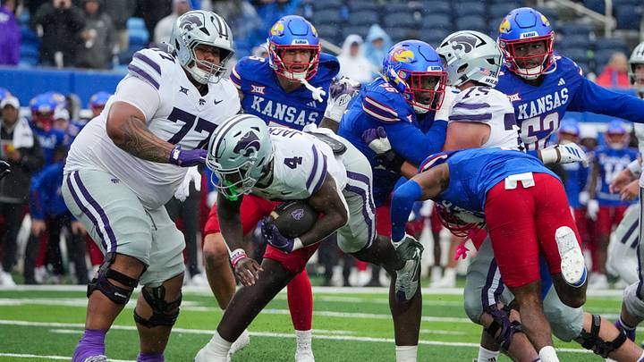 Oct 25, 2025; Lawrence, Kansas, USA; Kansas State Wildcats running back Joe Jackson (4) runs the ball as Kansas Jayhawks defensive back DJ Graham II (7) attempts the tackle during the second half of the game at David Booth Kansas Memorial Stadium. Mandatory Credit: Denny Medley-Imagn Images Oct 25, 2025; Lawrence, Kansas, USA; Kansas State Wildcats running back Joe Jackson (4) runs the ball as Kansas Jayhawks defensive back DJ Graham II (7) attempts the tackle during the second half of the game at David Booth Kansas Memorial Stadium. Mandatory Credit: Denny Medley-Imagn Images