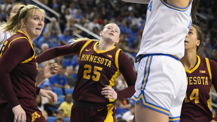 Feb 2, 2025; Los Angeles, California, USA; UCLA Bruins guard Gabriela Jaquez (11) scores between Minnesota Golden Gophers center Sophie Hart (52), Grace Grocholski (25) and Minnesota Golden Gophers forward Mallory Heyer (24) during the third quarter at Pauley Pavilion presented by Wescom. Mandatory Credit: Robert Hanashiro-Imagn Images