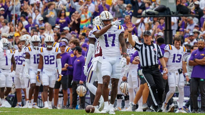 Nov 25, 2023; Baton Rouge, Louisiana, USA;  LSU Tigers wide receiver Chris Hilton Jr. (17) points to the student section after catching a 25 yard pass against Texas A&M Aggies defensive back Deuce Harmon (11) during the second half at Tiger Stadium. Mandatory Credit: Stephen Lew-Imagn Images
