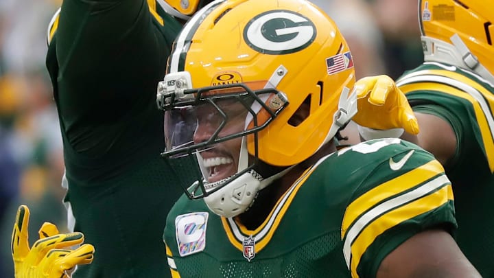 Green Bay Packers running back Josh Jacobs (8) celebrates a touchdown against the Bengals.