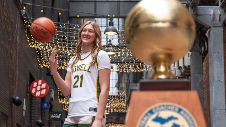Howell High School varsity basketball player Lilly Williams poses with her trophy in downtown Detroit on Monday, March 16, 2026, after being awarded 2026 Mick McCabe Miss Basketball winner.