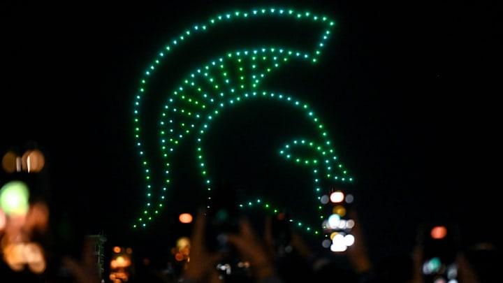 The Spartan helmet is formed during a drone light show at the Izzone campout on Friday, Oct. 4, 2024, at Munn Field in East Lansing.