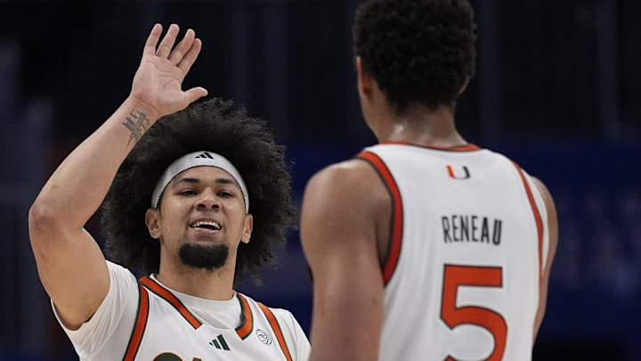 Mar 12, 2026; Charlotte, NC, USA; Miami (FL) Hurricanes guard Tre Donaldson (3) high fives forward Malik Reneau (5) in the final seconds against the Louisville Cardinals during the second half at Spectrum Center. Mandatory Credit: Jim Dedmon-Imagn Images