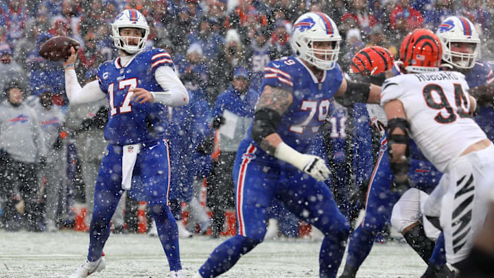 Buffalo Bills QB Josh Allen looks for an open receiver while teammate Spencer Brown looks to block Bengals' Sam Hubbard. Buffalo Bills QB Josh Allen looks for an open receiver while teammate Spencer Brown looks to block Bengals' Sam Hubbard.