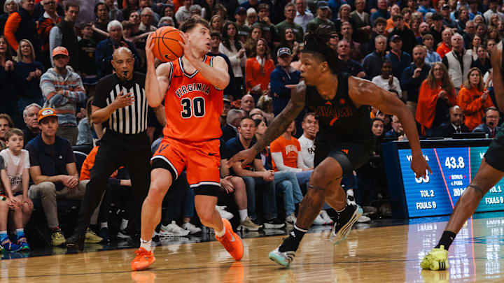 Virginia Cavaliers guard Dallin Hall and Miami Hurricanes forward Shelton Henderson 