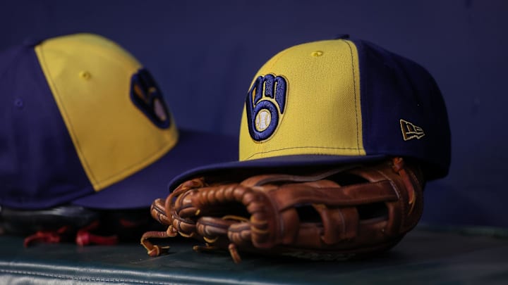 Jul 28, 2023; Atlanta, Georgia, USA; A detailed view of a Milwaukee Brewers hat and glove on the bench against the Atlanta Braves in the second inning at Truist Park. Mandatory Credit: Brett Davis-Imagn Images