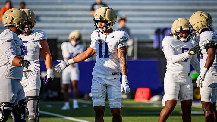 Ramzak Fruean slaps hands with his fellow UW defenders. Ramzak Fruean slaps hands with his fellow UW defenders.