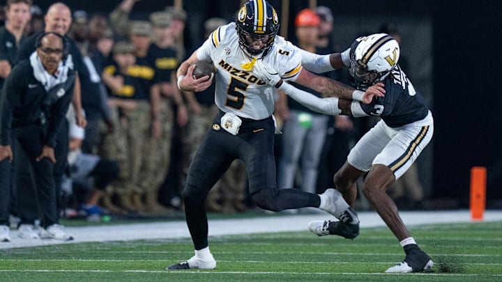 Missouri's quarterback Matt Zollers (5) is brought down by Vanderbilt's cornerback Kolbey Taylor (3) during their game at FirstBank Stadium in Nashville, Tenn., Saturday, Oct. 25, 2025.