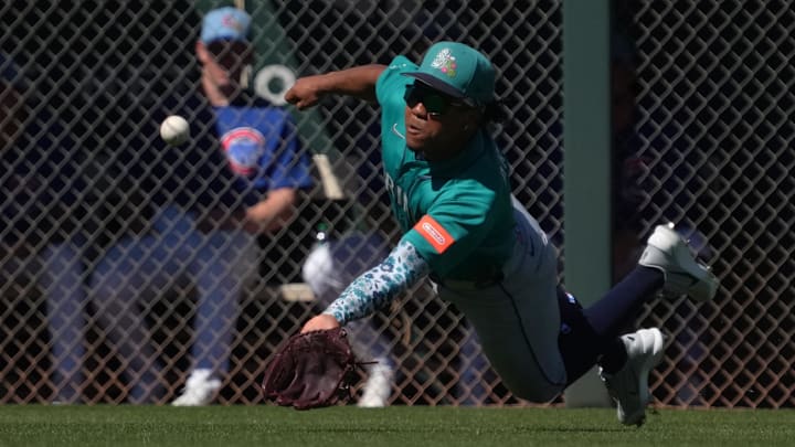 Mar 12, 2026; Mesa, Arizona, USA; Seattle Mariners shortstop Michael Arroyo (96) dives for the ball against the Chicago Cubs in the third inning at Sloan Park. Mandatory Credit: Rick Scuteri-Imagn Images