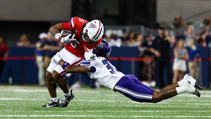 Sep 6, 2025; Tucson, Arizona, USA; Weber State Wildcats safety Tamal Johnson (31) tackles Arizona Wildcats wide receiver Gio Richardson (5) during the second quarter of the game at Arizona Stadium. Mandatory Credit: Aryanna Frank-Imagn Images