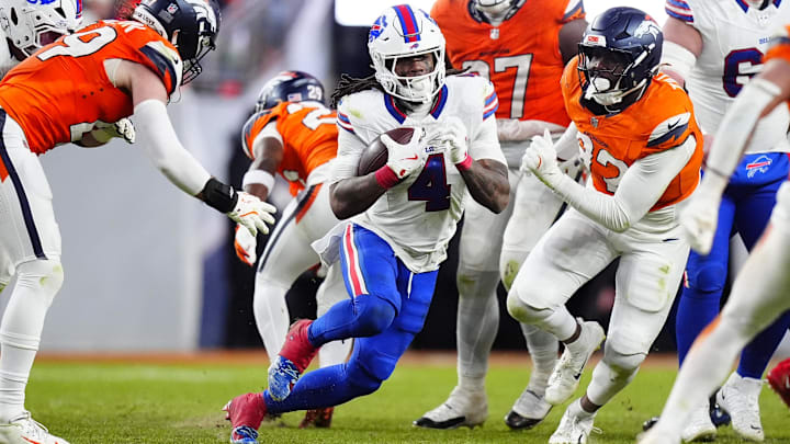 Jan 17, 2026; Denver, CO, USA; Buffalo Bills running back James Cook III (4) runs against Denver Broncos linebacker Alex Singleton (49) and linebacker Dondrea Tillman (92)