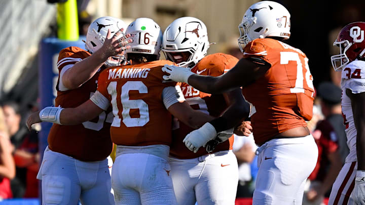 Texas Longhorns quarterback Arch Manning (16) celebrates with his lineman after he throws a touchdown against the Oklahoma Sooners during the second half at the Cotton Bowl. 