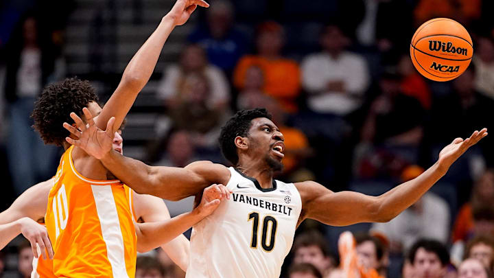 Vanderbilt forward Ak Okereke (10) and Tennessee forward Nate Ament (10) fight for the ball during the first half of a SEC tournament quarterfinal game at Bridgestone Arena in Nashville, Tenn., Friday, March 13, 2026.