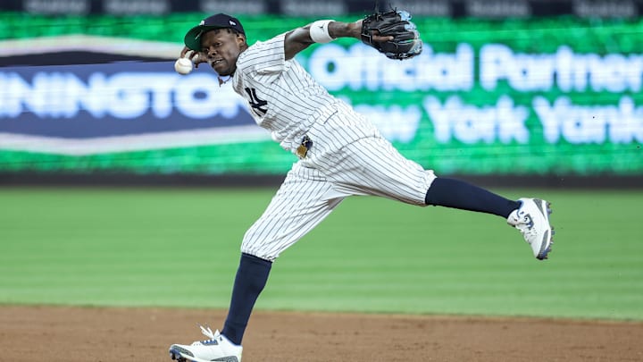 Apr 15, 2025; Bronx, New York, USA;  New York Yankees second baseman Jazz Chisholm Jr. (13) tries to make a running throw to first base in the fifth inning against the Kansas City Royals at Yankee Stadium. All players wore #42 for Jackie Robinson Day.  Mandatory Credit: Wendell Cruz-Imagn Images