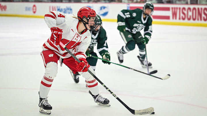 Wisconsin Badgers defender Caroline Harvey (4) makes a pass to set up a goal by Casey O'Brien (not seen) against the Bemidji State Beavers in the first period of a WCHA first-round game Saturday, March 1, 2025, at LaBahn Arena in Madison, Wisconsin.