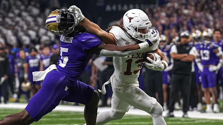 Texas Longhorns wide receiver Jordan Whittington (13) breaks a tackle by Washington linebacker Edefuan Ulofoshio (5) during the Sugar Bowl College Football Playoff  semifinals game at the Caesars Superdome on Monday, Jan. 1, 2024 in New Orleans, Louisiana.