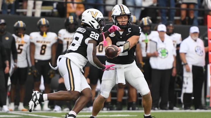 Oct 25, 2025; Nashville, Tennessee, USA; Vanderbilt Commodores quarterback Diego Pavia (2) hands off to running back Sedrick Alexander (28) against the Missouri Tigers during the fourth quarter at FirstBank Stadium. Mandatory Credit: Steve Roberts-Imagn Images Oct 25, 2025; Nashville, Tennessee, USA; Vanderbilt Commodores quarterback Diego Pavia (2) hands off to running back Sedrick Alexander (28) against the Missouri Tigers during the fourth quarter at FirstBank Stadium. Mandatory Credit: Steve Roberts-Imagn Images