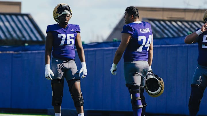 Elishah Jackett (76) chats up Drew Azzopardi during a break in spring ball. 