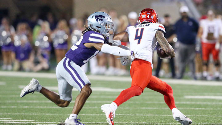 Sep 13, 2024; Manhattan, Kansas, USA; Kansas State Wildcats safety Nickendre Stiger (12) chases Arizona Wildcats wide receiver Tetairoa McMillan (4) during the third quarter at Bill Snyder Family Football Stadium. Sep 13, 2024; Manhattan, Kansas, USA; Kansas State Wildcats safety Nickendre Stiger (12) chases Arizona Wildcats wide receiver Tetairoa McMillan (4) during the third quarter at Bill Snyder Family Football Stadium.