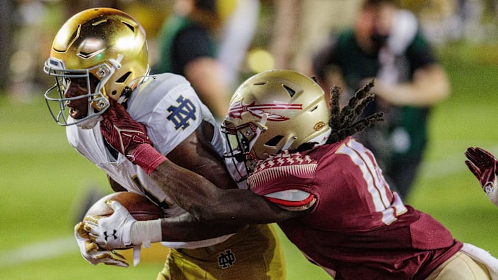 Notre Dame Fighting Irish wide receiver Kevin Austin Jr. (4) scores a touchdown as Florida State Seminoles defensive back Travis Jay (18) tackles him in the end zone. The Notre Dame Fighting Irish defeat the Florida State Seminoles 41-38 at Doak Campbell Stadium on Sunday, Sept. 5, 2021