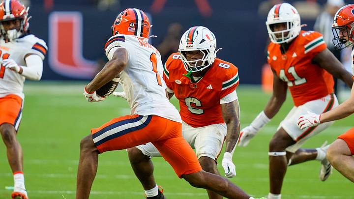 Nov 8, 2025; Miami Gardens, Florida, USA; Miami Hurricanes cornerback Xavier Lucas (6) tackles Syracuse Orange defensive back Demetres Samuel Jr. (1) during the second quarter at Hard Rock Stadium. Mandatory Credit: Jeff Romance-Imagn Images Nov 8, 2025; Miami Gardens, Florida, USA; Miami Hurricanes cornerback Xavier Lucas (6) tackles Syracuse Orange defensive back Demetres Samuel Jr. (1) during the second quarter at Hard Rock Stadium. Mandatory Credit: Jeff Romance-Imagn Images