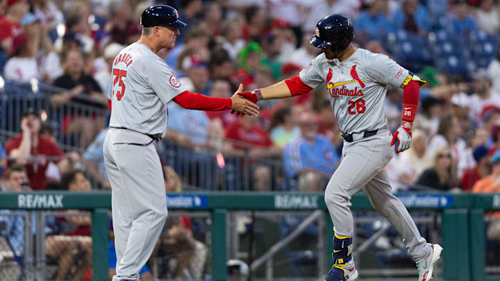 May 31, 2024; Philadelphia, Pennsylvania, USA; St. Louis Cardinals third base Nolan Arenado (28) shakes hands with third base coach Ron 'Pop' Warner (75) after hitting a home run during the seventh inning against the Philadelphia Phillies at Citizens Bank Park. Mandatory Credit: Bill Streicher-USA TODAY Sports