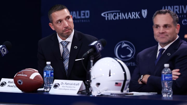 Dec 8, 2025; University Park, PA, USA; Matt Campbell, left, listens to Penn State University president Neeli Bendapudi speak as he is announced as the Penn State Nittany Lions new head coach during a press conference at the Beaver Stadium Press Room. Mandatory Credit: Matthew O'Haren-Imagn Images Dec 8, 2025; University Park, PA, USA; Matt Campbell, left, listens to Penn State University president Neeli Bendapudi speak as he is announced as the Penn State Nittany Lions new head coach during a press conference at the Beaver Stadium Press Room. Mandatory Credit: Matthew O'Haren-Imagn Images
