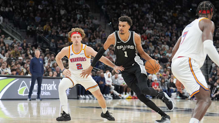 Nov 23, 2024; San Antonio, Texas, USA;  San Antonio Spurs center Victor Wembanyama (1) dribbles past Golden State Warriors guard Brandin Podziemski (2) in the second half at Frost Bank Center. Mandatory Credit: Daniel Dunn-Imagn Images