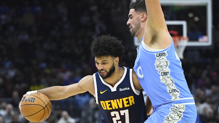 Dec 5, 2024; Cleveland, Ohio, USA; Denver Nuggets guard Jamal Murray (27) drives against Cleveland Cavaliers forward Georges Niang (20) in the second quarter at Rocket Mortgage FieldHouse. Mandatory Credit: David Richard-Imagn Images