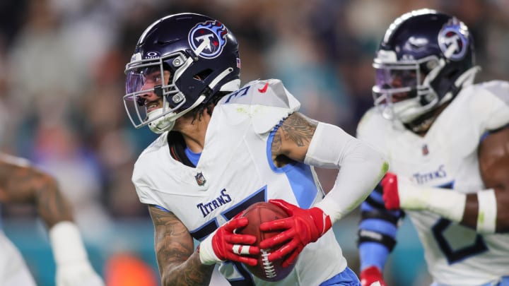 Dec 11, 2023; Miami Gardens, Florida, USA; Tennessee Titans safety Amani Hooker (37) runs with the football after recovering a blocked kicked attempt against the Miami Dolphins during the second quarter at Hard Rock Stadium. Mandatory Credit: Sam Navarro-USA TODAY Sports