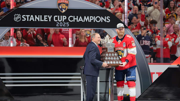 NHL commissioner Gary Bettman presents Florida Panthers center Sam Bennett (9) the Conn Smythe Trophy