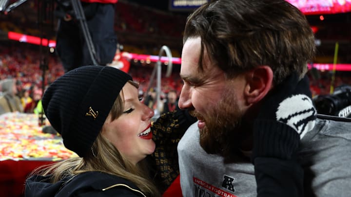 Jan 26, 2025; Kansas City, MO, USA; Recording artist Taylor Swift  and Kansas City Chiefs tight end Travis Kelce (87) react after the AFC Championship game against the Buffalo Bills at GEHA Field at Arrowhead Stadium. 