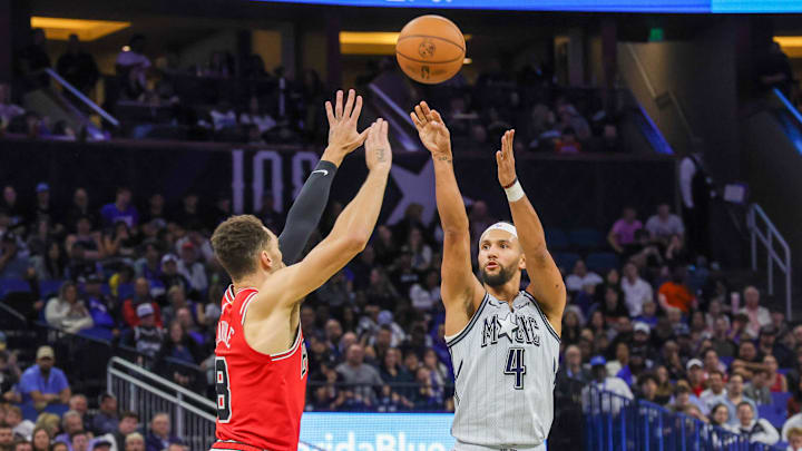 Orlando Magic guard Jalen Suggs (4) shoots the ball against Chicago Bulls guard Zach LaVine (8) during the second quarter at Kia Center.