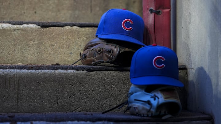 Sep 20, 2025; Cincinnati, Ohio, USA; Chicago player hats are seen on the dugout steps during the game between the Chicago Cubs and the Cincinnati Reds at Great American Ball Park. Mandatory Credit: Aaron Doster-Imagn Images