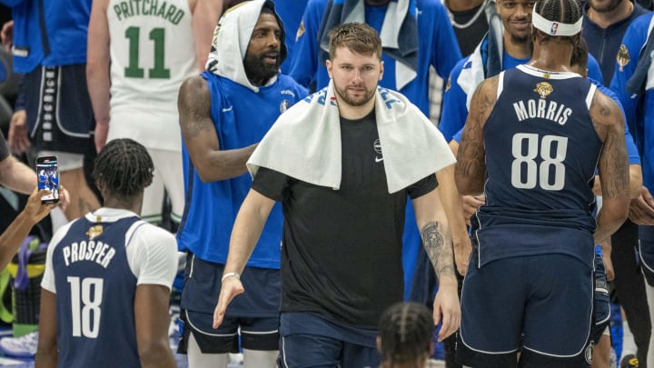 Jun 14, 2024; Dallas, Texas, USA; Dallas Mavericks guard Luka Doncic (77) and guard Kyrie Irving (11) walk off the court after the Mavericks defeat the Boston Celtics in game four of the 2024 NBA Finals at American Airlines Center. Mandatory Credit: Jerome Miron-USA TODAY Sports