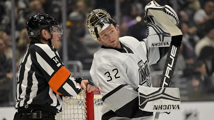 Feb 18, 2023; Los Angeles, California, USA;  Los Angeles Kings goaltender Jonathan Quick (32) talks with referee Trevor Hanson (14) during a stoppage in play against the Arizona Coyotes at Crypto.com Arena. Mandatory Credit: Jayne Kamin-Oncea-Imagn Images