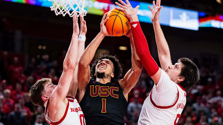 USC's Desmond Claude shoots the ball during the second half against Nebraska's Connor Essegian (left) and Berke Buyuktuncel.