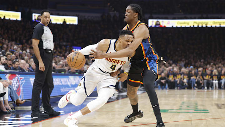 May 5, 2025; Oklahoma City, Oklahoma, USA; Denver Nuggets guard Russell Westbrook (4) drives against Oklahoma City Thunder forward Jalen Williams (8) during the second quarter during game one of the second round for the 2025 NBA Playoffs at Paycom Center. Mandatory Credit: Alonzo Adams-Imagn Images