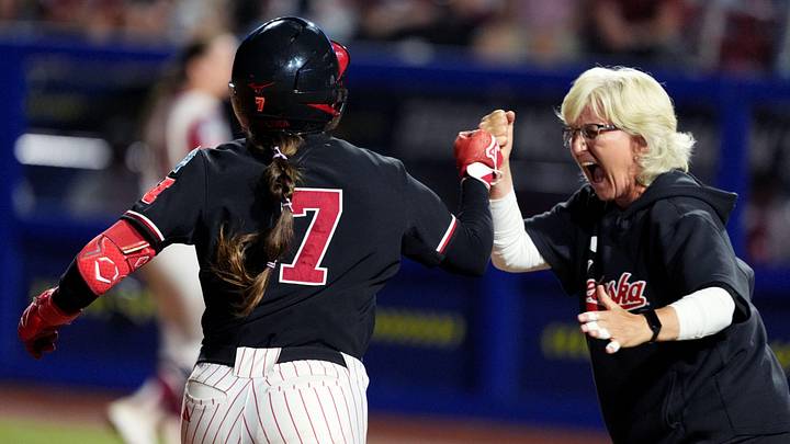 Nebraska head softball coach Rhonda Revelle celebrates the walk-off home run of Ava Kuszak (7) in the tenth inning during a Women's College World Series softball game between the Arkansas Razorbacks and the Nebraska Cornhuskers at Devon Park in Oklahoma City, May 28, 2026. Nebraska head softball coach Rhonda Revelle celebrates the walk-off home run of Ava Kuszak (7) in the tenth inning during a Women's College World Series softball game between the Arkansas Razorbacks and the Nebraska Cornhuskers at Devon Park in Oklahoma City, May 28, 2026.