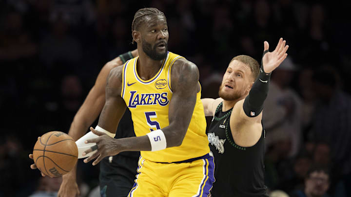 Oct 29, 2025; Minneapolis, Minnesota, USA; Los Angeles Lakers center Deandre Ayton (5) looks to pass the ball as Minnesota Timberwolves guard Donte DiVincenzo (0) plays defense in the first half at Target Center. Mandatory Credit: Jesse Johnson-Imagn Images