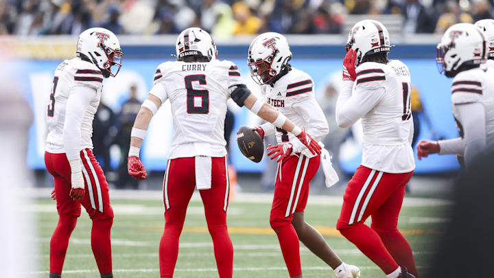 Nov 29, 2025; Morgantown, West Virginia, USA; Texas Tech Red Raiders cornerback Brice Pollock (14) celebrates after an interception during the second quarter against the West Virginia Mountaineers at Milan Puskar Stadium. Mandatory Credit: Ben Queen-Imagn Images