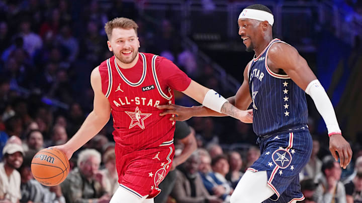 Feb 18, 2024; Indianapolis, Indiana, USA; Western Conference forward Luka Doncic (77) of the Dallas Mavericks dribbles the ball against Eastern Conference center Bam Adebayo (13) of the Miami Heat during the first half of the 73rd NBA All Star game at Gainbridge Fieldhouse. Mandatory Credit: Kyle Terada-Imagn Images