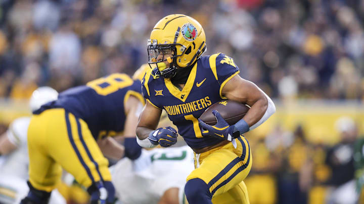 Nov 16, 2024; Morgantown, West Virginia, USA; West Virginia Mountaineers running back Jahiem White (1) runs the ball during the first quarter against the Baylor Bears at Mountaineer Field at Milan Puskar Stadium. Mandatory Credit: Ben Queen-Imagn Images