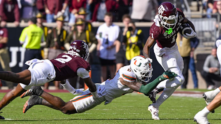 Dec 20, 2025; College Station, TX, USA; Texas A&M Aggies wide receiver Mario Craver (1) eludes the tackle of Miami Hurricanes defensive back Keionte Scott (0) during the game between the Aggies and the Hurricanes at Kyle Field. Mandatory Credit: Jerome Miron-Imagn Images Dec 20, 2025; College Station, TX, USA; Texas A&M Aggies wide receiver Mario Craver (1) eludes the tackle of Miami Hurricanes defensive back Keionte Scott (0) during the game between the Aggies and the Hurricanes at Kyle Field. Mandatory Credit: Jerome Miron-Imagn Images