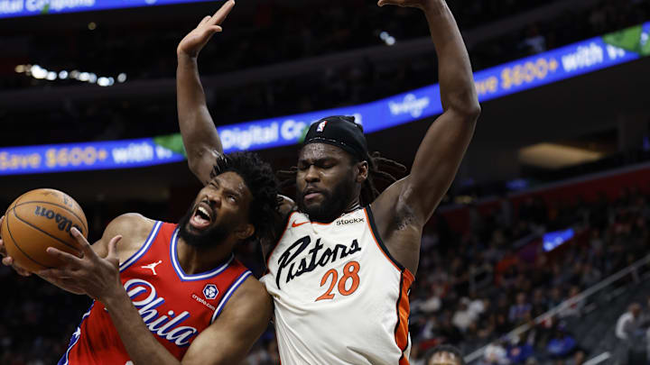 Feb 7, 2025; Detroit, Michigan, USA;  Philadelphia 76ers center Joel Embiid (21) is defended by Detroit Pistons center Isaiah Stewart (28): Rick Osentoski-Imagn Images