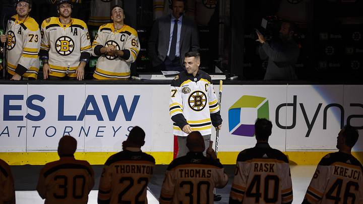 Oct 11, 2023; Boston, Massachusetts, USA; Former Boston Bruins captain Patrice Bergeron joins other former Bruins  players before the start of Boston s 100th season in the NHL at TD Garden. Mandatory Credit: Winslow Townson-Imagn Images
